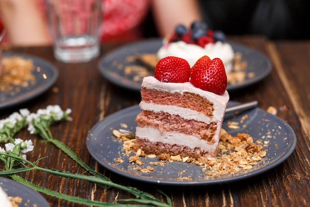 Torte dolci con bacche di estate su un tavolo di legno