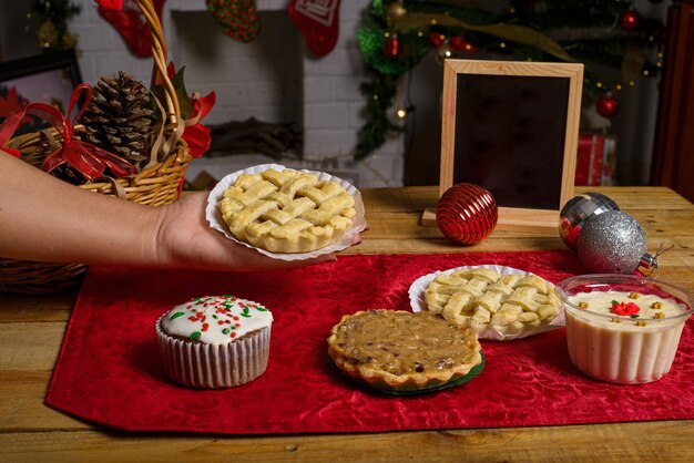 Sweet canapes and pastries on a table with a Christmas background