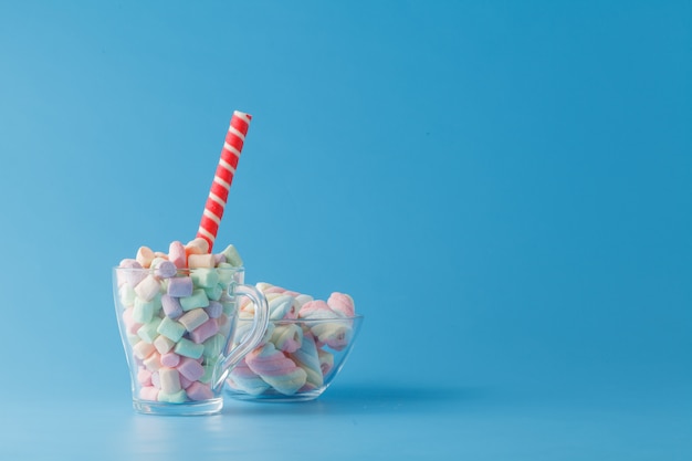 Sweet candies on blue color table