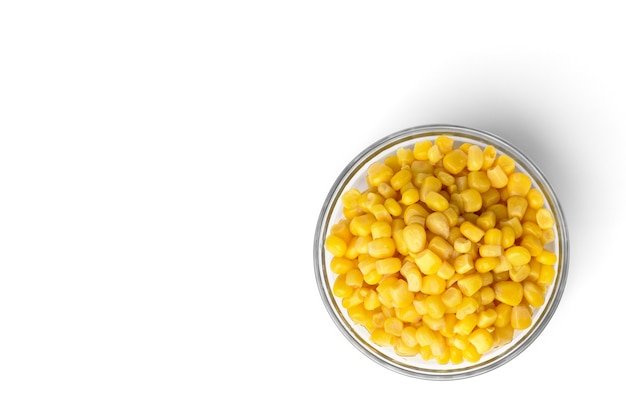 Sweet canned corn in glass bowl isolated on white background.