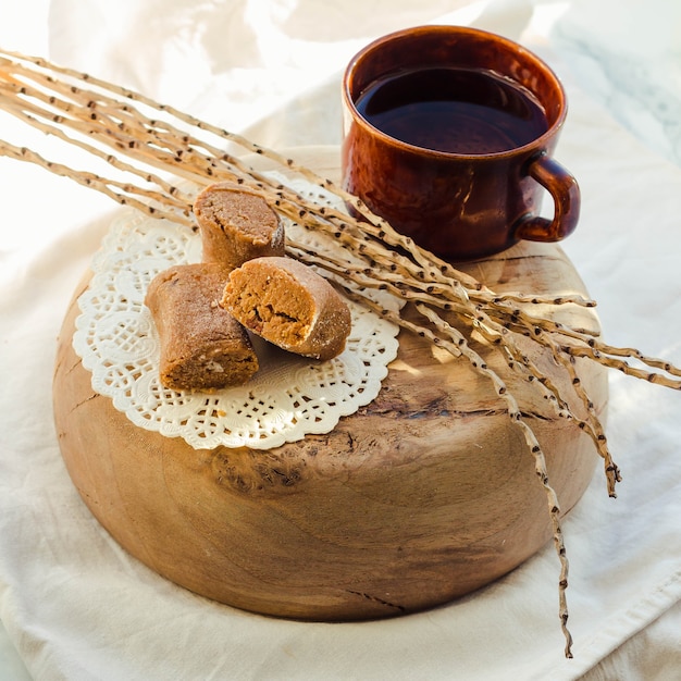 Sweet caramel toffee caramels on wooden plate and light.