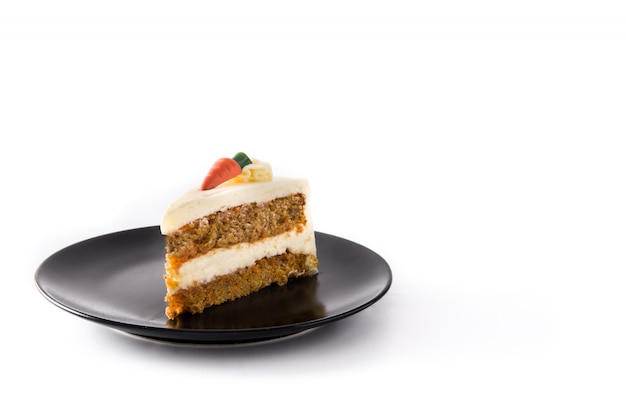 Sweet carrot cake slice on a plate isolated on white background.