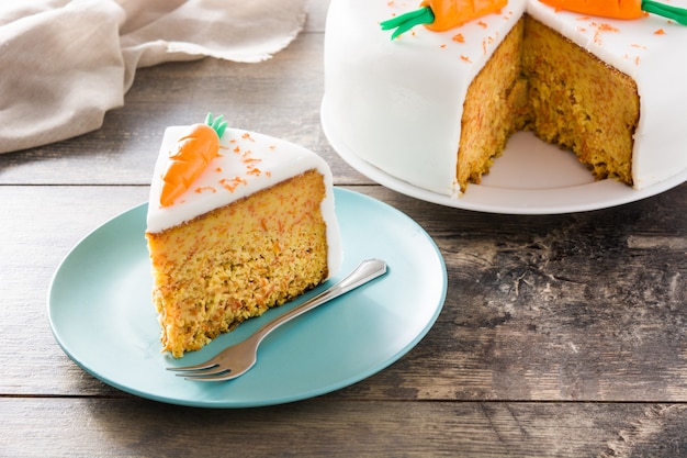 Sweet carrot cake slice on wooden table