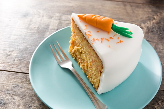 Sweet carrot cake slice on wooden table