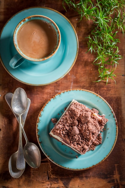 Sweet cheesecake served with coffee in blue porcelain