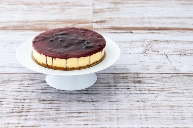 Sweet cheesecake with blue berry on wooden table