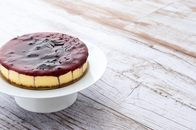 Sweet cheesecake with blue berry on wooden table