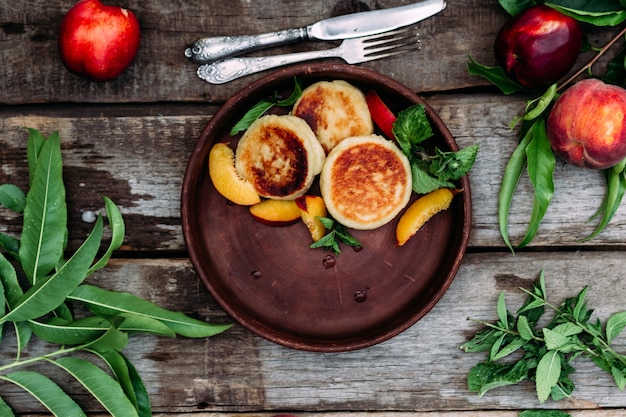 Sweet cheesecakes with peach in a plate closeup Breakfast