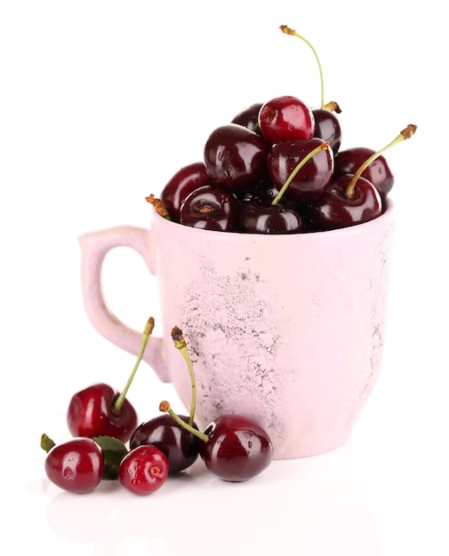 Sweet cherries in mug isolated on white