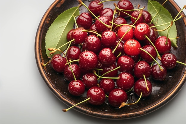 Sweet cherries on a plate with leaves adorned in droplets