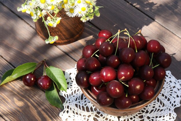 sweet cherries on wooden table in the garden
