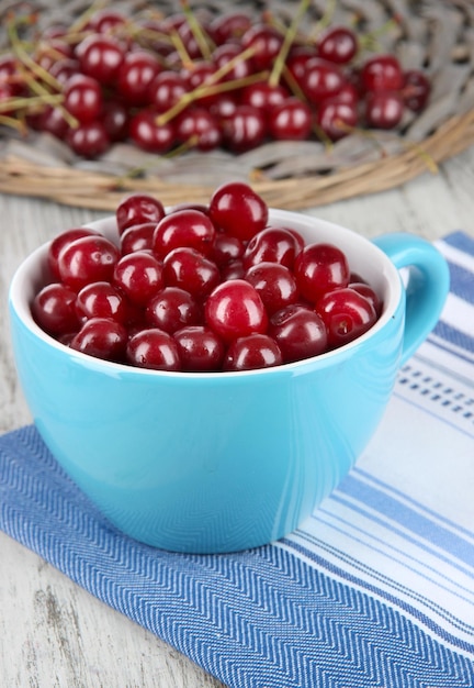 Sweet cherry in cup on table closeup