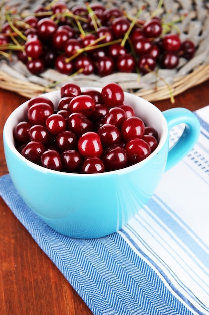 Sweet cherry in cup on table closeup