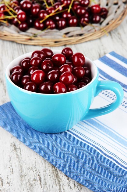 Sweet cherry in cup on table closeup