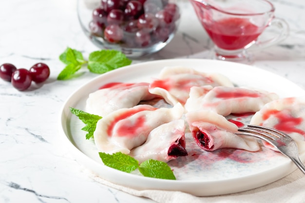 Sweet cherry dumplings served with cherry sauce