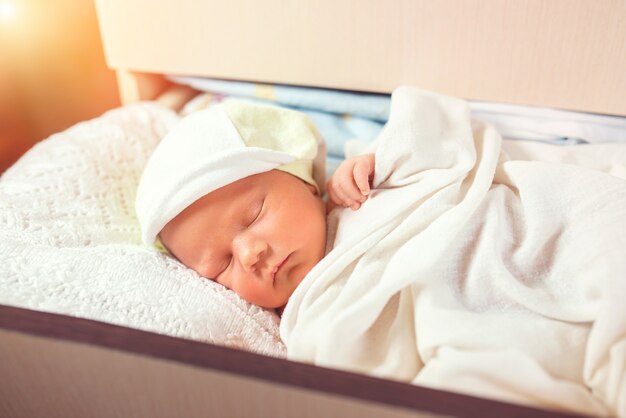 Sweet child resting in shelf in the dresser