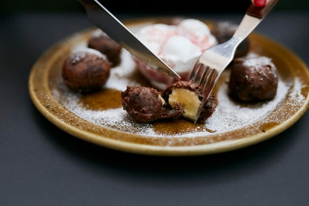 sweet chocolate balls with filling inside on a plate close-up