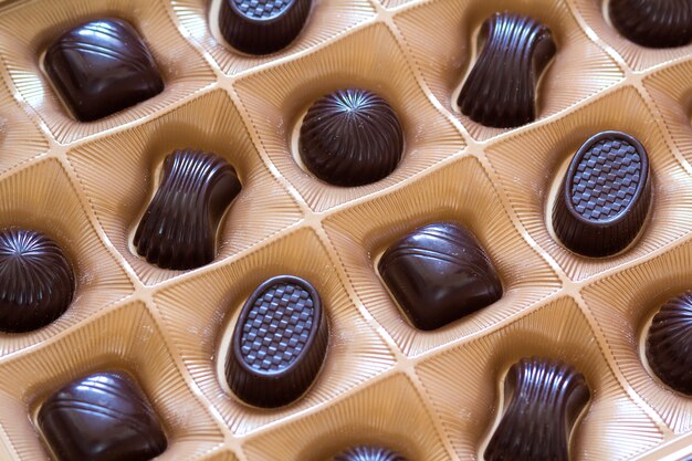 Sweet chocolate candies assortment in a box close-up. Top view