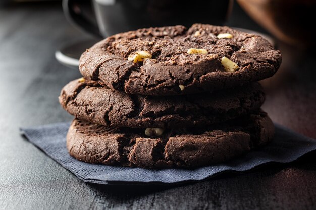 Sweet chocolate cookies on black table