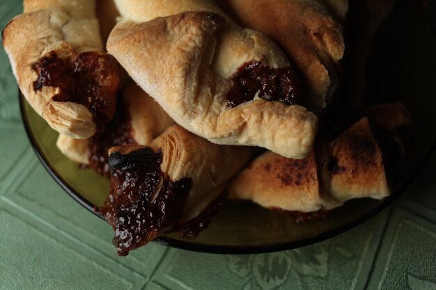 Sweet Chocolate Croissants, selective focus on old vintage background. Fresh homemade croissants with chocolate. Croissant with chocolate topping on the plate.