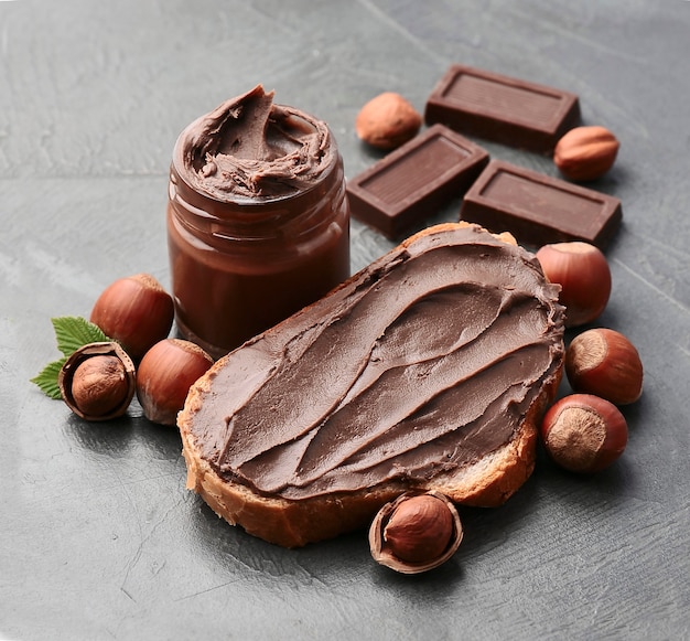 Sweet chocolate paste with hazelnuts nuts and chocolate closeup. chocolate dessert. healthy breakfast