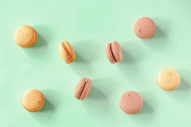 Sweet chocolatelemon macaronscookies lying on green background pastry confectionery desserts tasty sugar foodcopy space