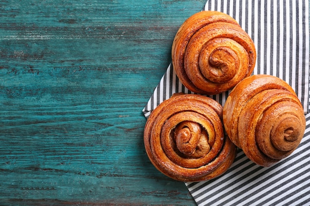 Sweet cinnamon rolls on table