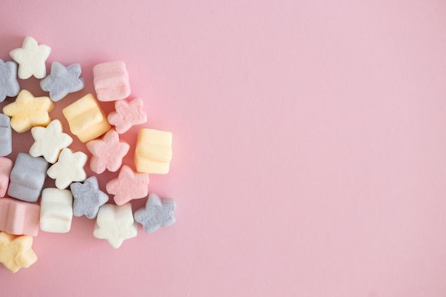 Sweet color candy in the form of stars on pink background