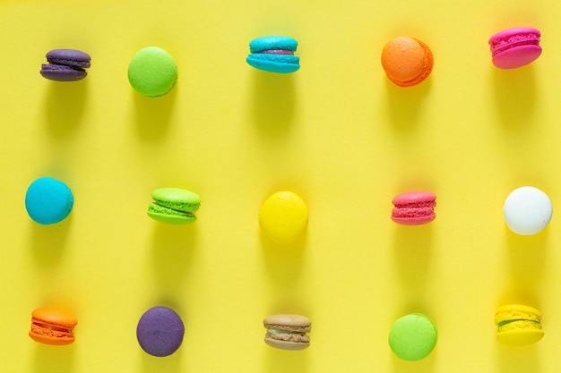 Sweet and colorful french macaroons or macaroon on yellow background