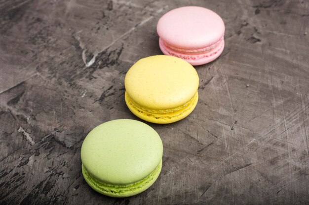 Sweet colorful macarons on dark background