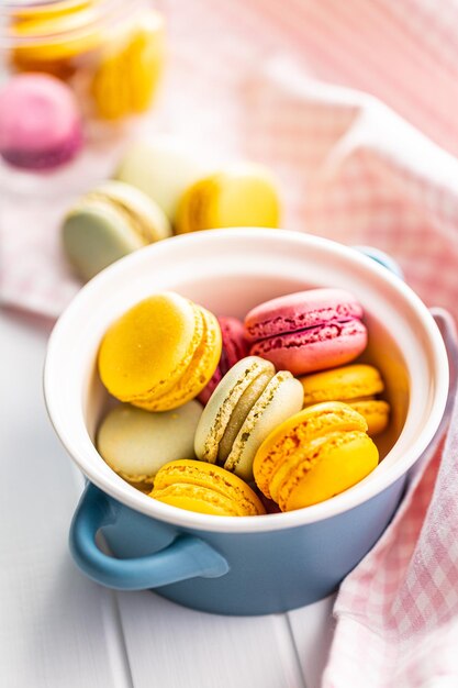 Sweet colorful macarons traditional french macaroons tasty dessert in the pot