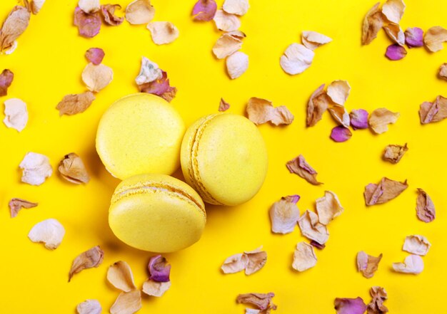 Sweet colorful macaroons on yellow background