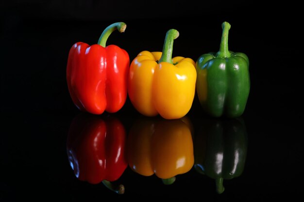 Sweet colorful paprika isolated on dark background with reflex