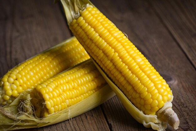 Sweet corn cooked on wooden background ripe corn cobs steamed or boiled sweetcorn for food vegan dinner or snack