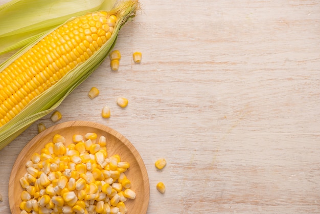 Sweet corn seeds on a wooden plate