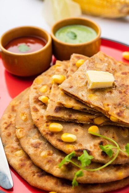 Photo sweet corn stuffed paratha or parotha served in a plate indian flatbread recipe made filling makai