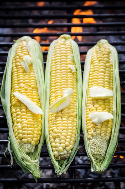 Sweet corncob on grill with butter and salt