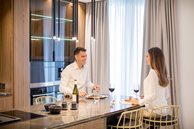 Sweet couple having a romantic dinner at luxury kitchen