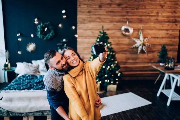 Sweet couple taking selfie in studio