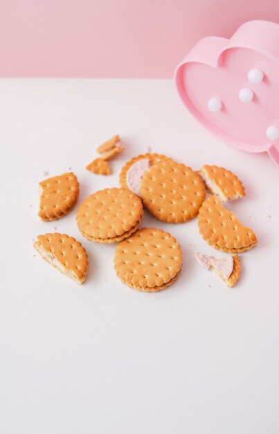 Sweet creamy filling crackers on a white pink pastel background