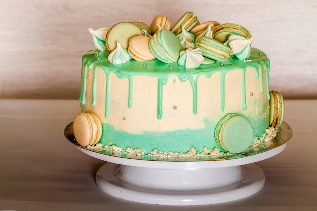 Sweet creamy green cake with macaroons on top