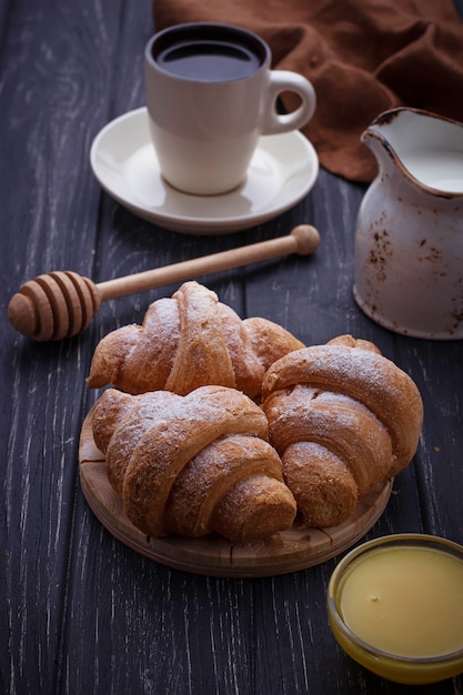 Sweet croissants, honey and coffee