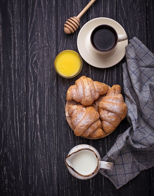 Sweet croissants, honey and coffee