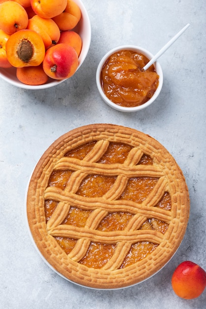 Sweet crust cake with apricots and apricot jam, top down view image with copy space