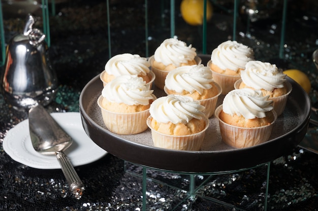 Sweet cupcakes with protein cream on a dark background