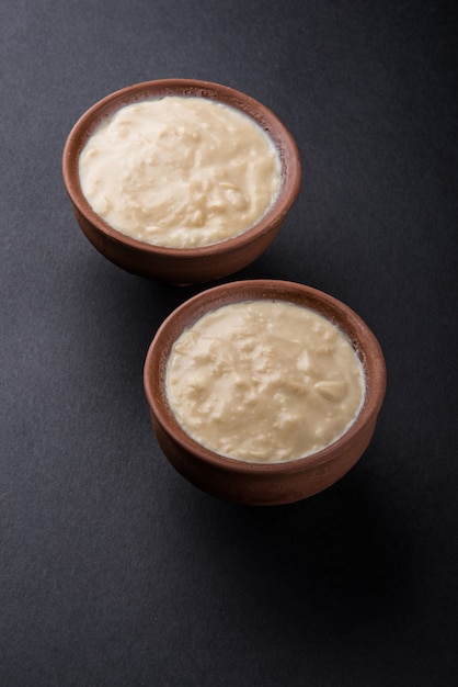 Sweet curd or sweet dahi in hindi, served in earthen pot, selective focus