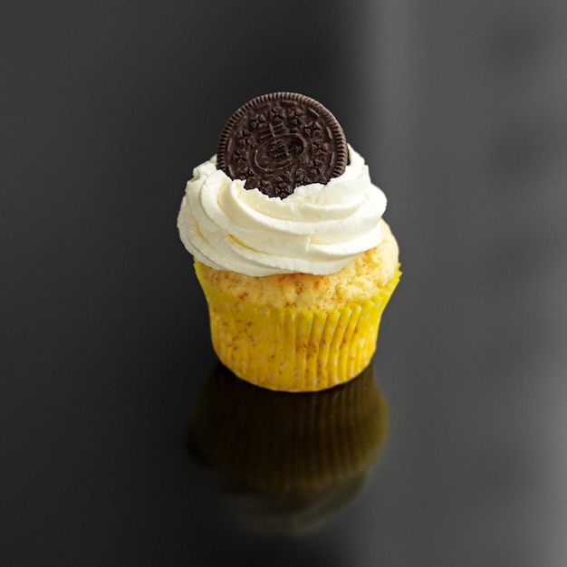 Sweet delicious cupcake with cream and cookies The concept of food desserts holiday