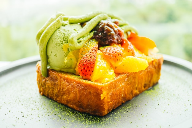 Sweet dessert bread toast with matcha ice cream and strawberry , orange