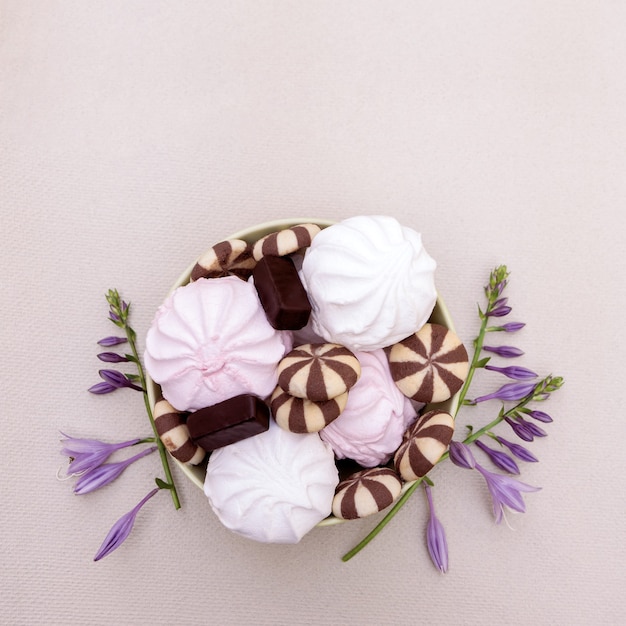 Sweet dessert made of white and pink marshmallows with cookies and chocolates.