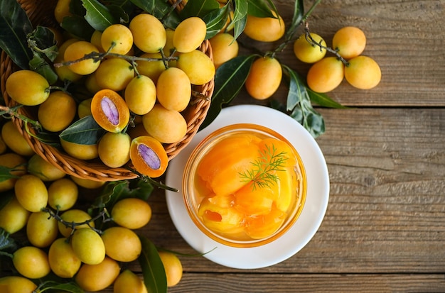 Sweet dessert marian plum fruit on bowl for food and wooden background tropical fruit Name in Thailand sweet Yellow Marian Plum Maprang Plango or Mayong chid